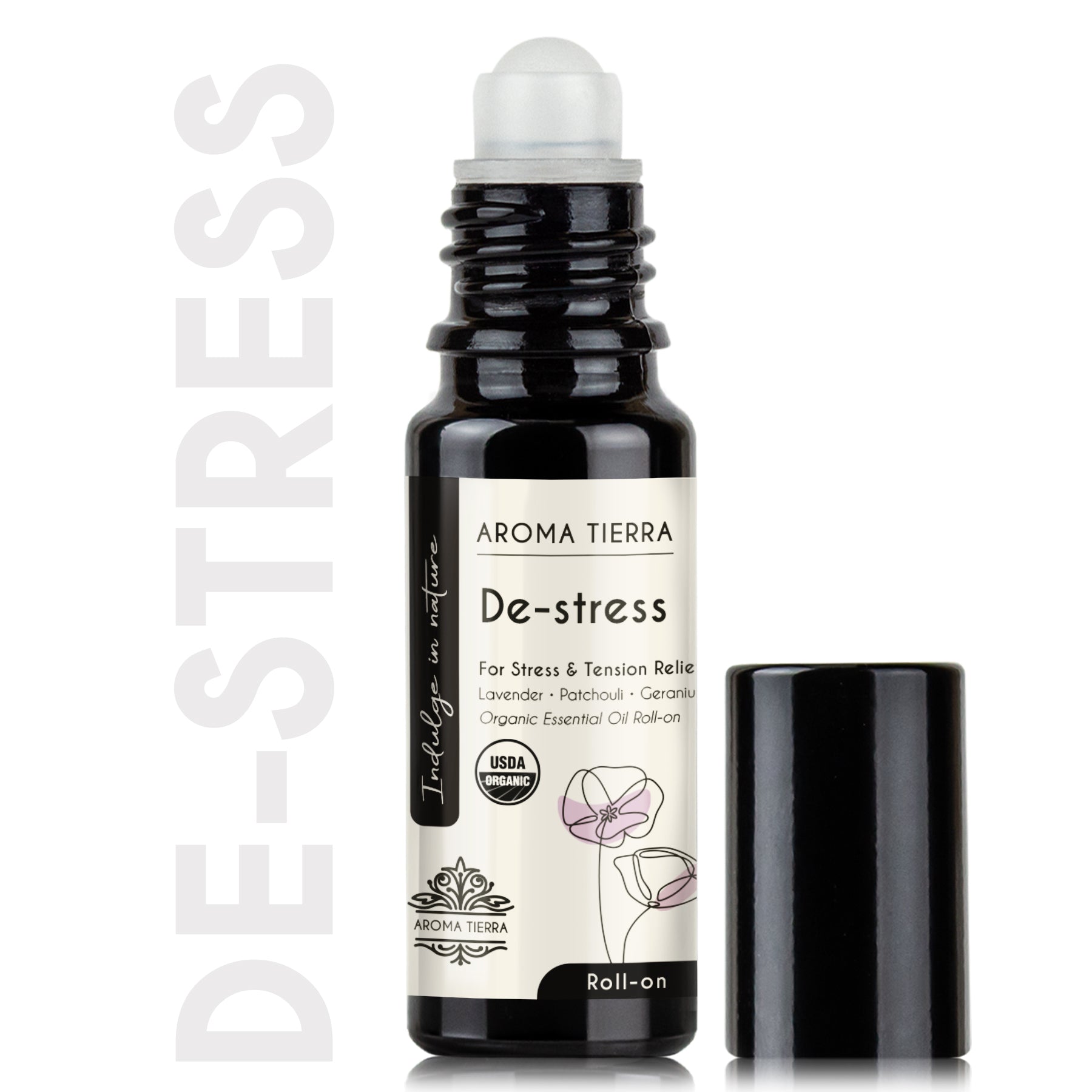 A roll-on bottle labeled 'De-stress' with a white cap, black body, and a floral design, indicating it is an essential oil blend for stress relief.