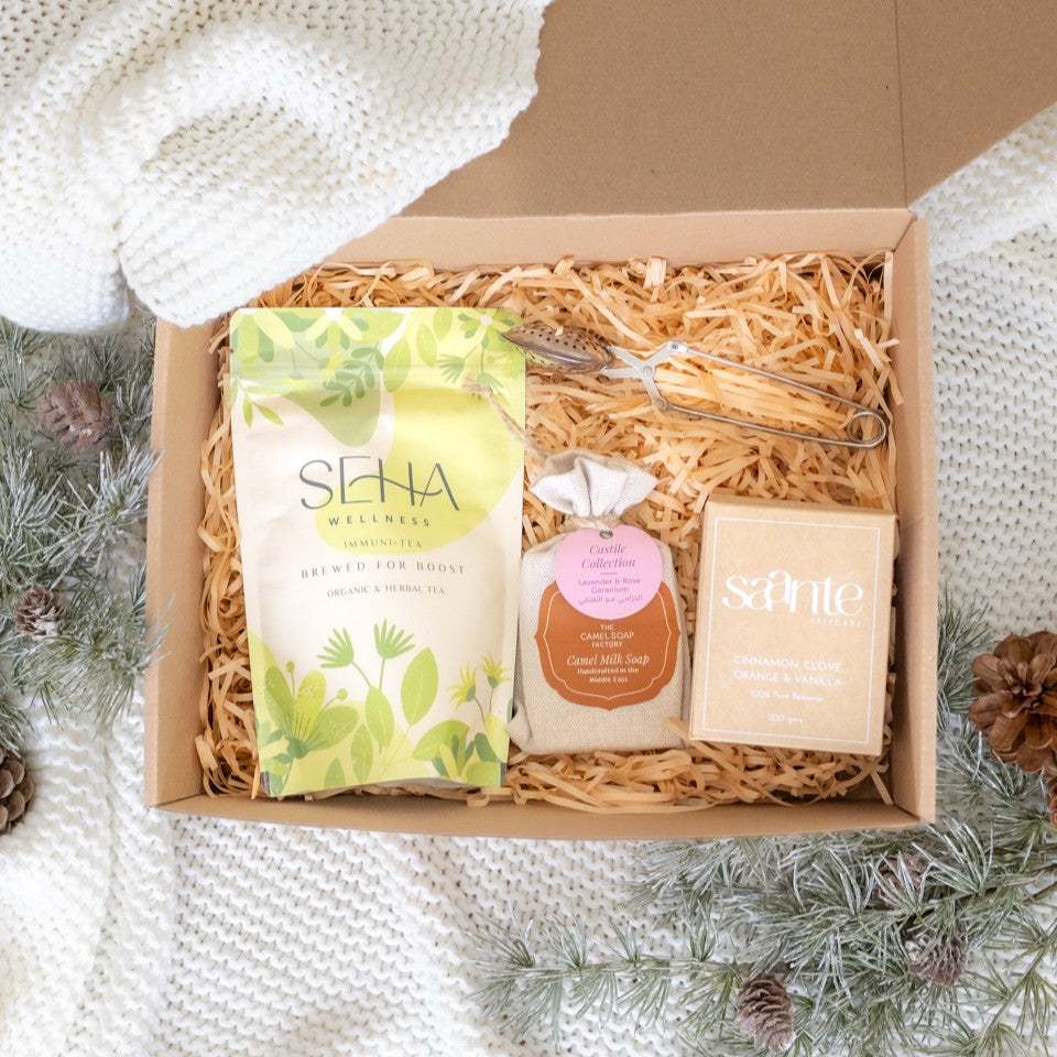 Cozy Christmas gift box arranged with festive holiday elements, showcasing a warm and inviting seasonal bundle.