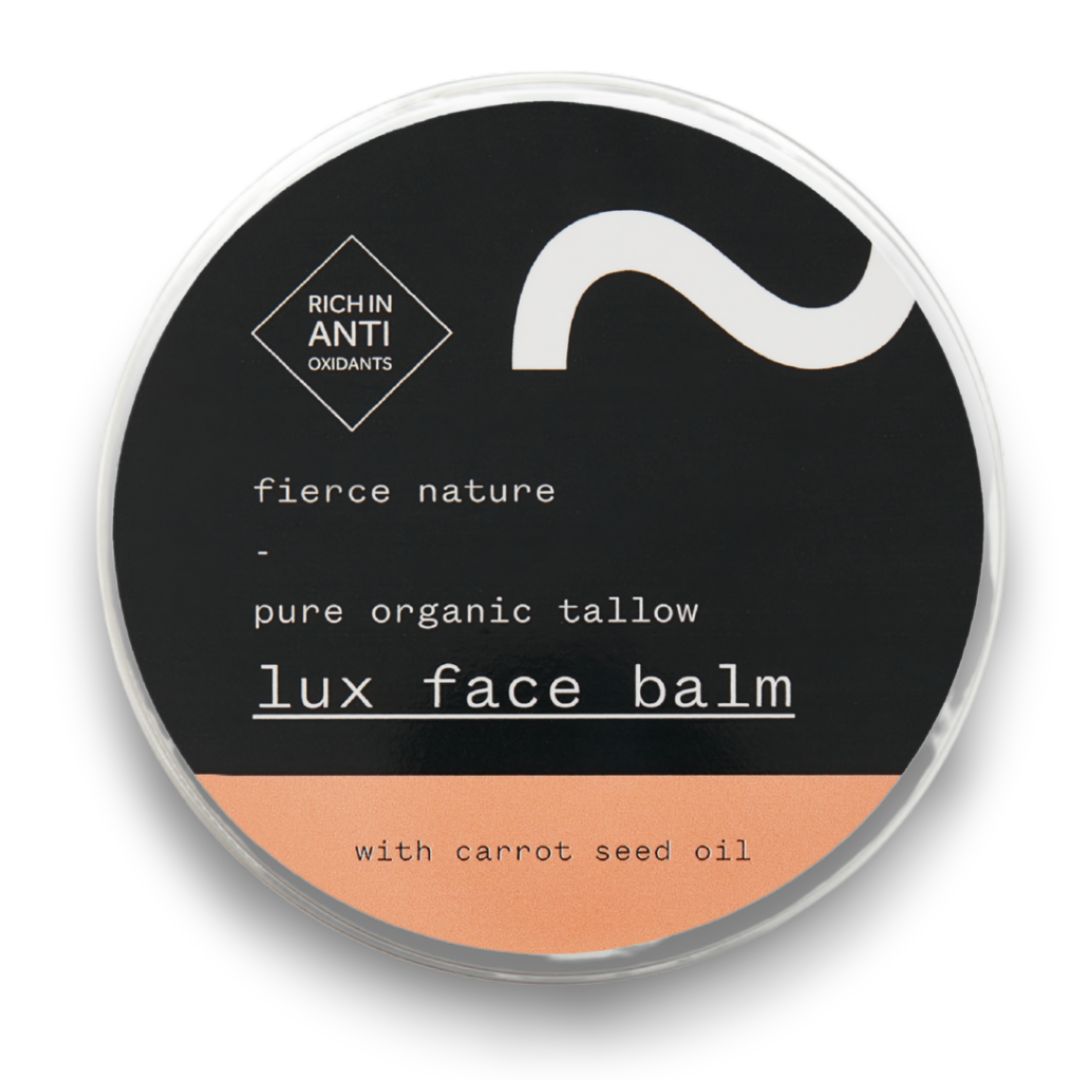 Lux face balm container with black label and peach-colored base on a white background